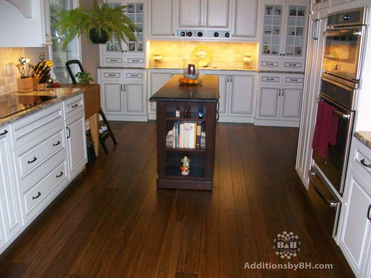 remodeled kitchen, hardwood floor with a center island, with our logo.